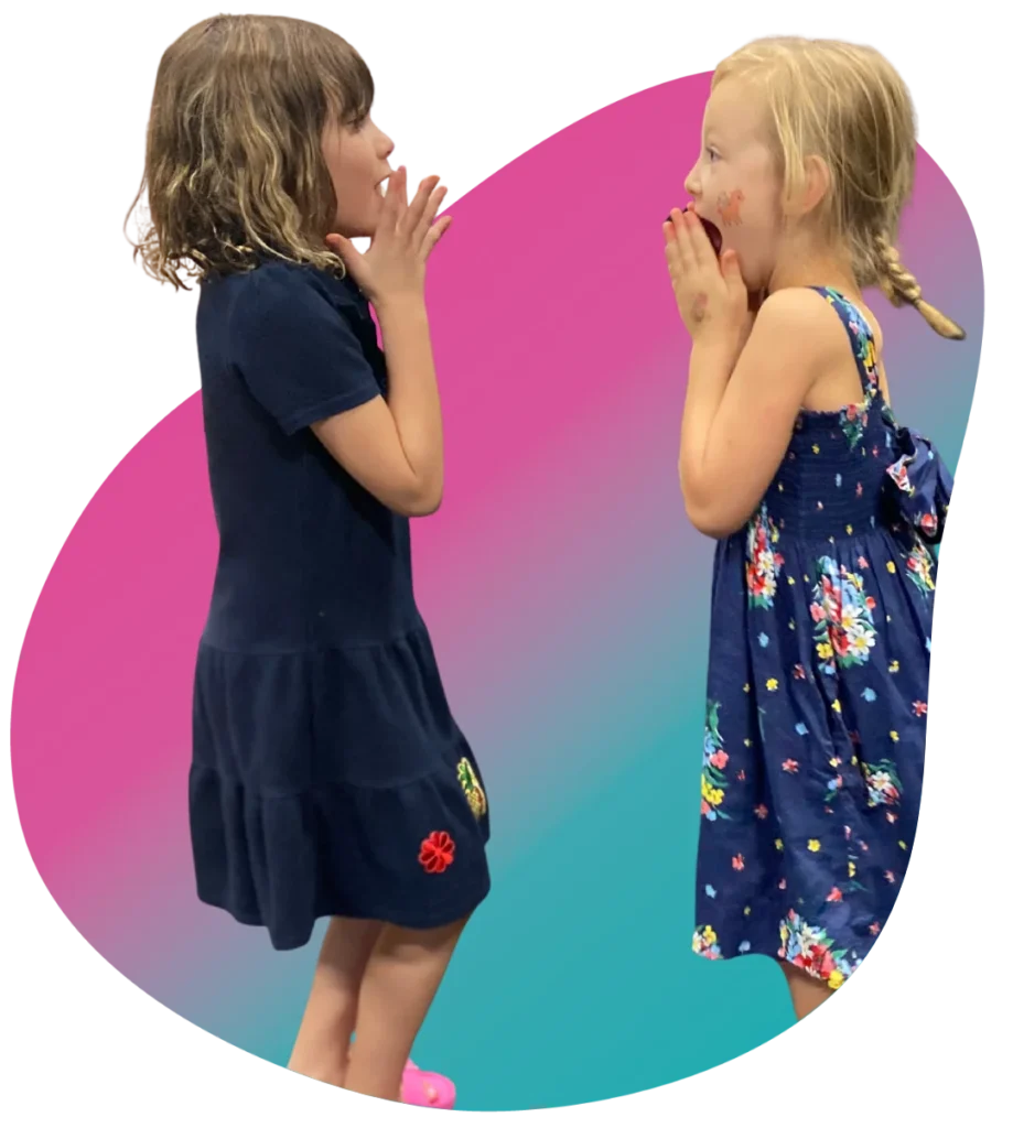 What are Group Acting Classes at FAME Performing Arts Two young girls acting out a dramatic gasp face-to-face in a FAME group acting class exercise.